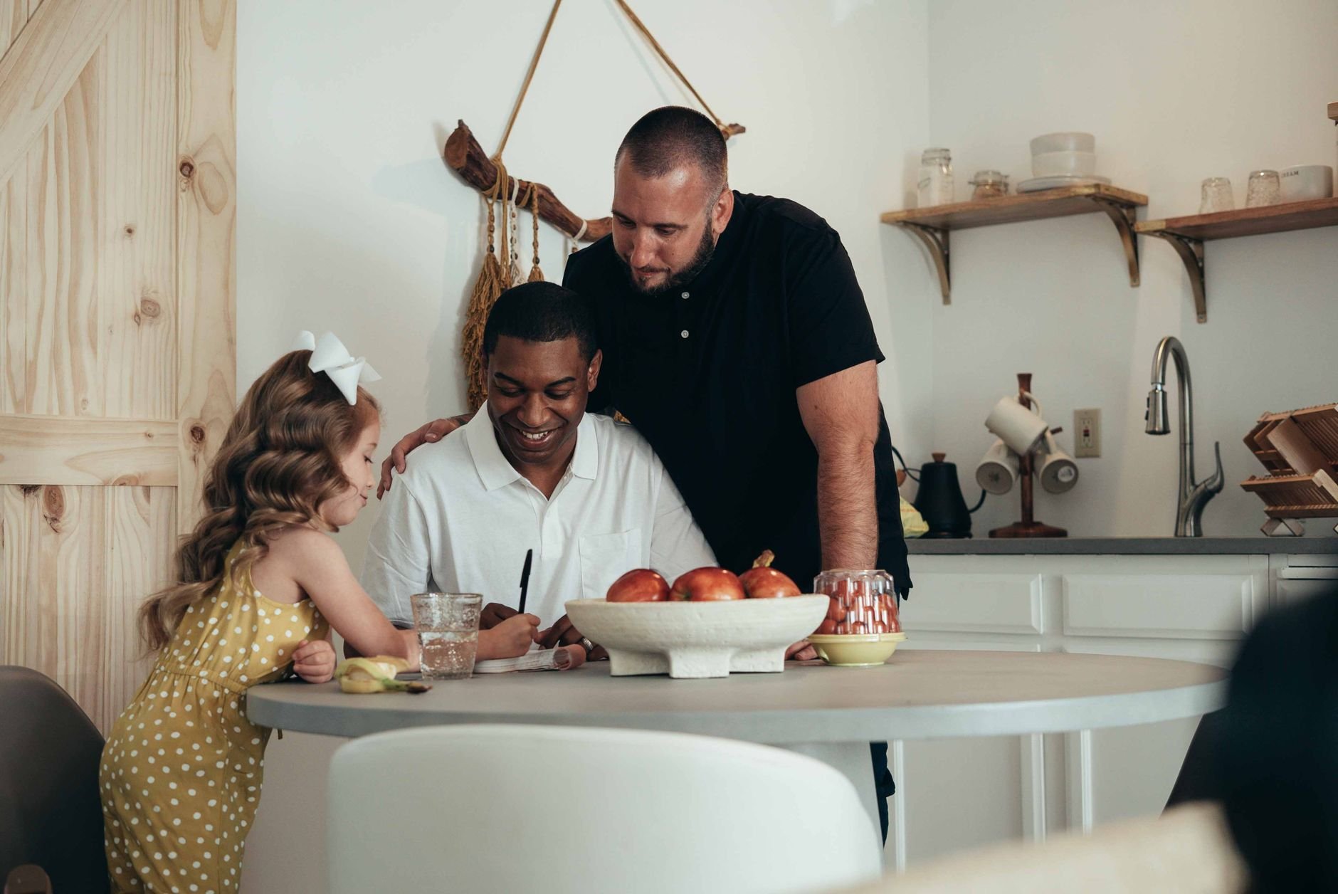 A joyful family enjoying time together in a warm and cozy kitchen setting.